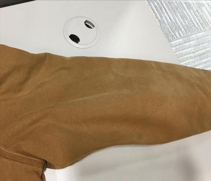 Sleeve of brown jacket after it has been cleaned
