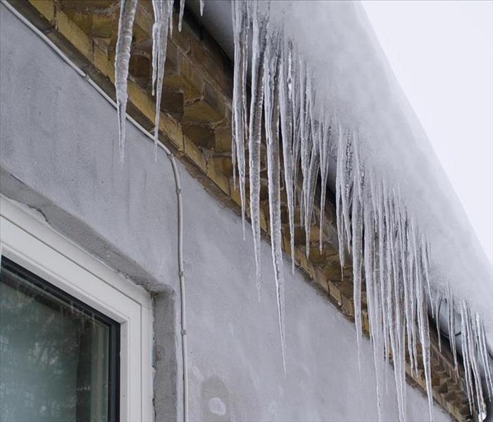 Ice-cycles hanging from a home roof