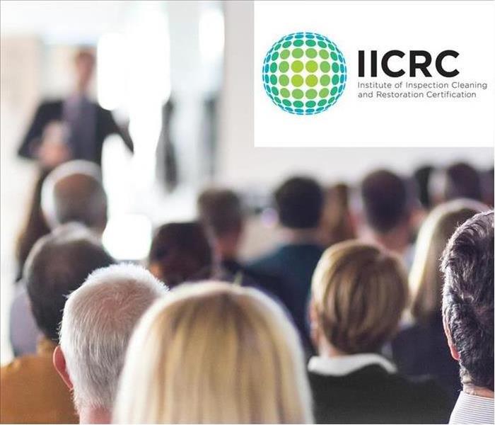 People in a meeting. IICRC Logo 