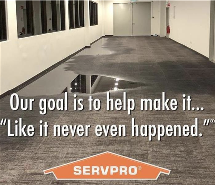Flooded hallway with SERVPRO logo that says: Our goal is to help make it... "Like it never even happened."